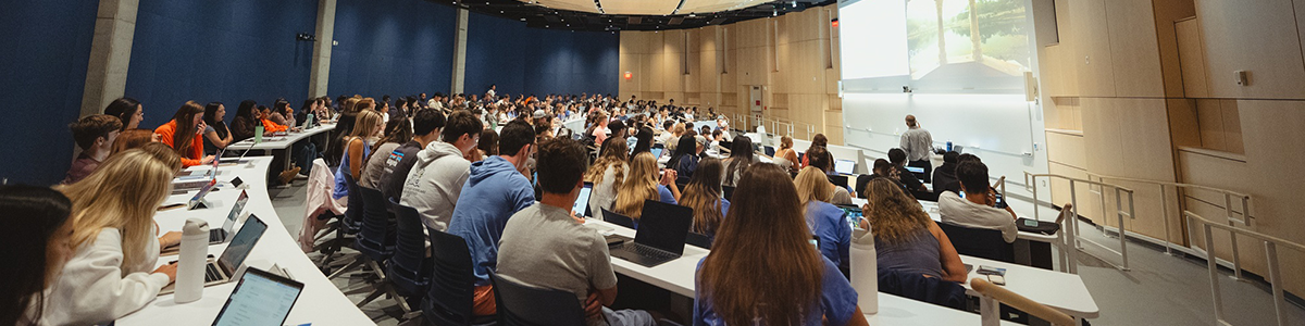 Large group of students learning in auditorium